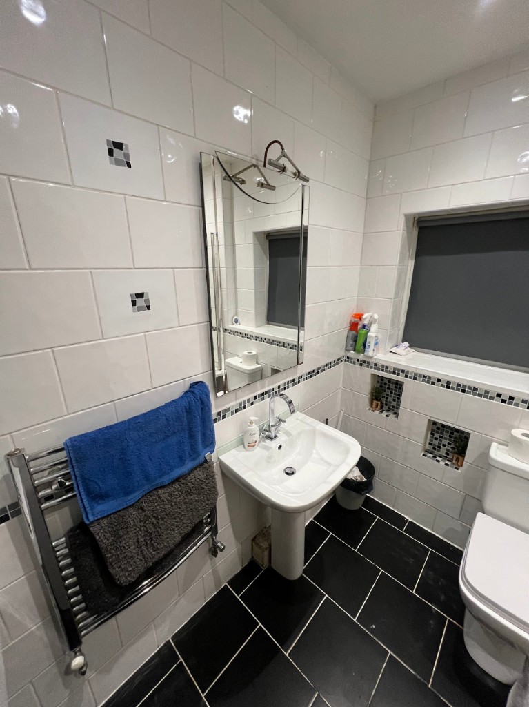 Bathroom before renovation, Sunderland — white tiled bathroom with pedestal sink