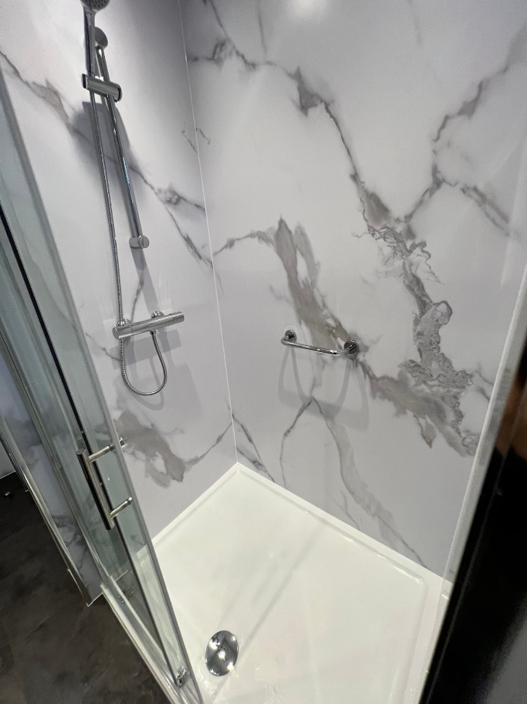Walk-in shower installation in Seaburn, Sunderland — marble-effect panels and chrome fittings